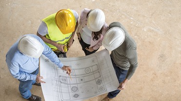 Construction workers looking at plans