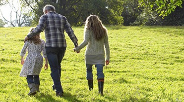 Family walking in a field